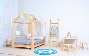 View of cozy child's room interior with cute bed