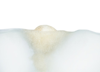 Bath bomb in water on white background