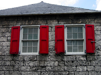 Red Window Shutters on a Stone Wall in Nassau, Bahamas