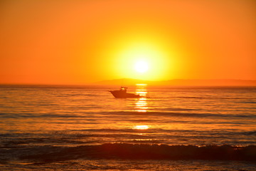 Boat on ocean at sunset