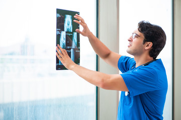 Young handsome doctor working in the hospital 