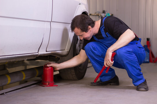 Mechanic Uses Jackscrew