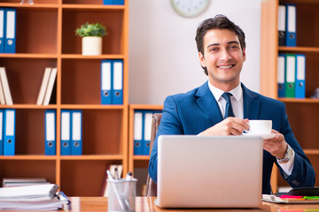 Young handsome businessman working in the office