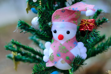 Snowman on the Christmas tree with decorations on special days.