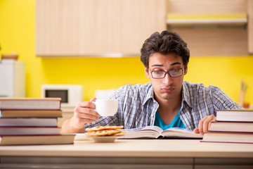 Student preparing for exam sitting at the kitchen 