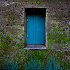 old blue window on worn structure