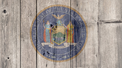 USA Politics News Concept: US State New York Seal Wooden Fence Background