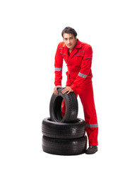 Young garage worker with tyre isolated on white