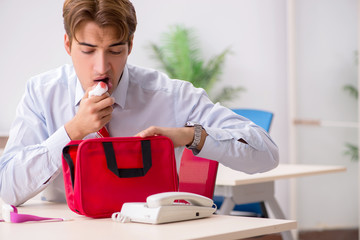 Man with first aid kit in the office