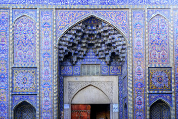 Exterior of Nasir al-Mulk Mosque facade. Persian text at the right door means visiting-hours  of the mosque as English text at the left door. Shiraz, Iran.