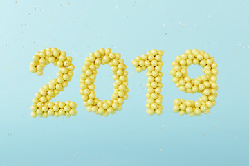New year 2019. yellow balloons number and Confetti on pastel blue background. 3d rendering
