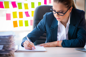 Beautiful female employee with many conflicting priorities 