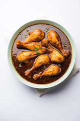 Chicken leg / drumstick curry or Murg Tangri/tangdi masala. Served in a bowl over moody background. Selective focus