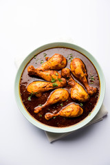 Chicken leg / drumstick curry or Murg Tangri/tangdi masala. Served in a bowl over moody background. Selective focus
