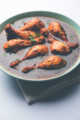 Chicken leg / drumstick curry or Murg Tangri/tangdi masala. Served in a bowl over moody background. Selective focus