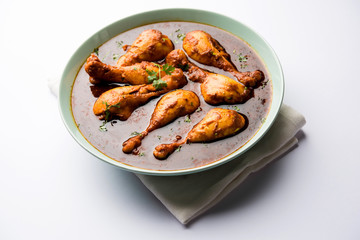 Chicken leg / drumstick curry or Murg Tangri/tangdi masala. Served in a bowl over moody background. Selective focus