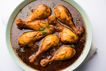 Chicken leg / drumstick curry or Murg Tangri/tangdi masala. Served in a bowl over moody background. Selective focus