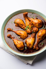 Chicken leg / drumstick curry or Murg Tangri/tangdi masala. Served in a bowl over moody background. Selective focus