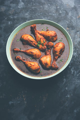 Chicken leg / drumstick curry or Murg Tangri/tangdi masala. Served in a bowl over moody background. Selective focus