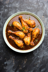 Chicken leg / drumstick curry or Murg Tangri/tangdi masala. Served in a bowl over moody background. Selective focus