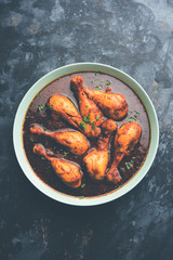 Chicken leg / drumstick curry or Murg Tangri/tangdi masala. Served in a bowl over moody background. Selective focus