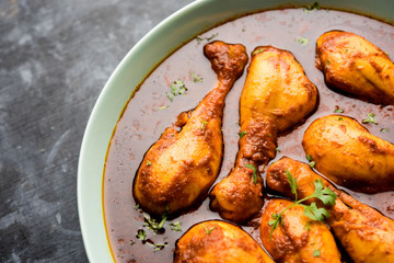 Chicken leg / drumstick curry or Murg Tangri/tangdi masala. Served in a bowl over moody background. Selective focus