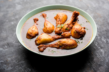 Chicken leg / drumstick curry or Murg Tangri/tangdi masala. Served in a bowl over moody background. Selective focus