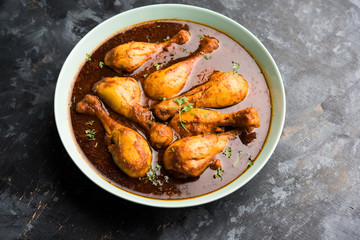 Chicken leg / drumstick curry or Murg Tangri/tangdi masala. Served in a bowl over moody background. Selective focus