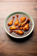 Chicken leg / drumstick curry or Murg Tangri/tangdi masala. Served in a bowl over moody background. Selective focus