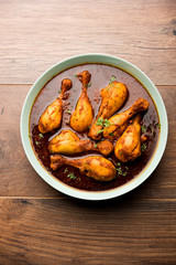 Chicken leg / drumstick curry or Murg Tangri/tangdi masala. Served in a bowl over moody background. Selective focus