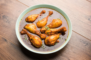 Chicken leg / drumstick curry or Murg Tangri/tangdi masala. Served in a bowl over moody background. Selective focus