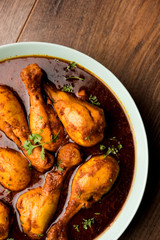 Chicken leg / drumstick curry or Murg Tangri/tangdi masala. Served in a bowl over moody background. Selective focus