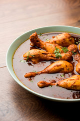 Chicken leg / drumstick curry or Murg Tangri/tangdi masala. Served in a bowl over moody background. Selective focus