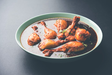 Chicken leg / drumstick curry or Murg Tangri/tangdi masala. Served in a bowl over moody background. Selective focus