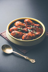 Chicken leg / drumstick curry or Murg Tangri/tangdi masala. Served in a bowl over moody background. Selective focus