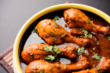 Chicken leg / drumstick curry or Murg Tangri/tangdi masala. Served in a bowl over moody background. Selective focus