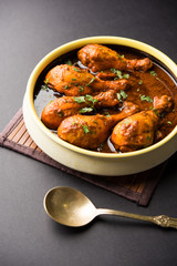 Chicken leg / drumstick curry or Murg Tangri/tangdi masala. Served in a bowl over moody background. Selective focus