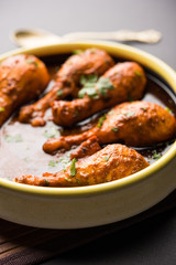 Chicken leg / drumstick curry or Murg Tangri/tangdi masala. Served in a bowl over moody background. Selective focus