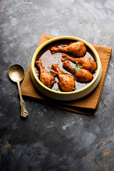 Chicken leg / drumstick curry or Murg Tangri/tangdi masala. Served in a bowl over moody background. Selective focus
