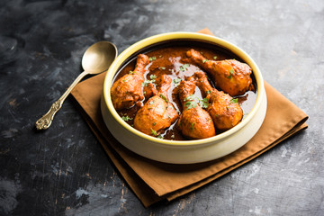 Chicken leg / drumstick curry or Murg Tangri/tangdi masala. Served in a bowl over moody background. Selective focus
