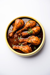 Chicken leg / drumstick curry or Murg Tangri/tangdi masala. Served in a bowl over moody background. Selective focus