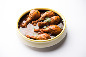 Chicken leg / drumstick curry or Murg Tangri/tangdi masala. Served in a bowl over moody background. Selective focus