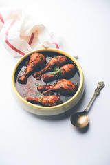 Chicken leg / drumstick curry or Murg Tangri/tangdi masala. Served in a bowl over moody background. Selective focus