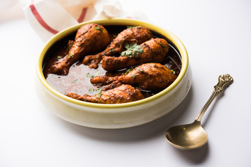 Chicken leg / drumstick curry or Murg Tangri/tangdi masala. Served in a bowl over moody background. Selective focus