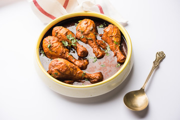 Chicken leg / drumstick curry or Murg Tangri/tangdi masala. Served in a bowl over moody background. Selective focus