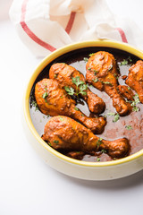 Chicken leg / drumstick curry or Murg Tangri/tangdi masala. Served in a bowl over moody background. Selective focus