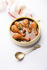 Chicken leg / drumstick curry or Murg Tangri/tangdi masala. Served in a bowl over moody background. Selective focus