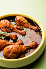 Chicken leg / drumstick curry or Murg Tangri/tangdi masala. Served in a bowl over moody background. Selective focus