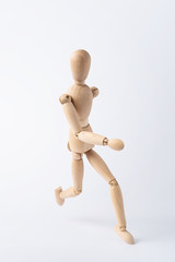 running wooden mannequin isolated on white background