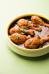 Chicken leg / drumstick curry or Murg Tangri/tangdi masala. Served in a bowl over moody background. Selective focus